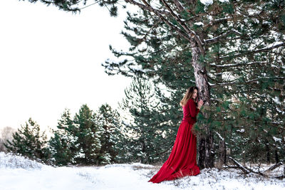 Woman with umbrella on snow covered land