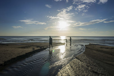 Scenic view of beach against sky during sunset