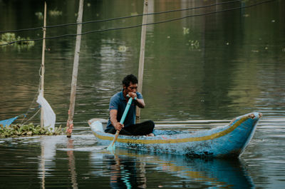 Side view of man in boat on lake