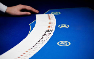 Close-up of human hand on blue table