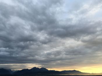 Scenic view of dramatic sky over silhouette landscape