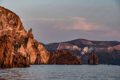 Scenic view of sea and mountains against sky