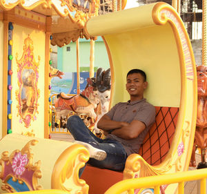 Portrait of smiling young woman in amusement park