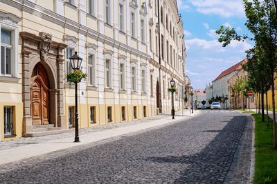 Street amidst buildings in city against sky