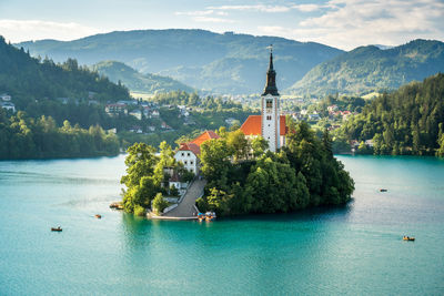 Scenic view of building on mountain against sky