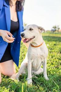 Woman with dog on field