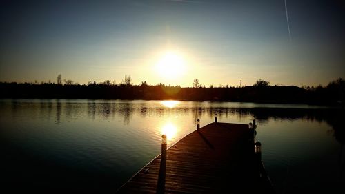 Scenic view of lake against sky during sunset
