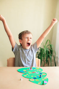 Portrait of boy playing with toy on table