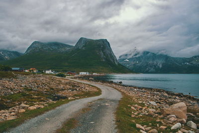 Road by mountain against sky