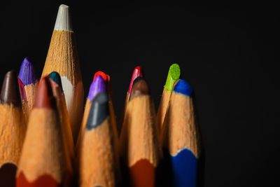 Close-up of colored pencils against black background