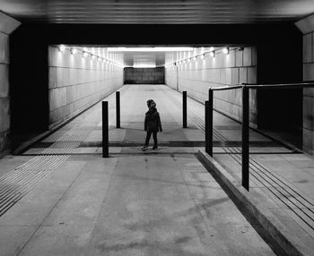 Rear view of kid walking in tunnel