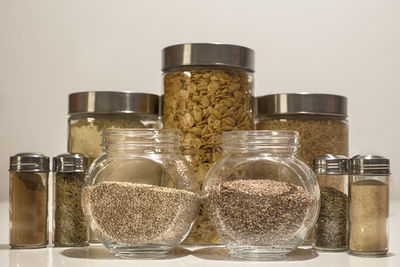 Close-up of glass jar on table against white background