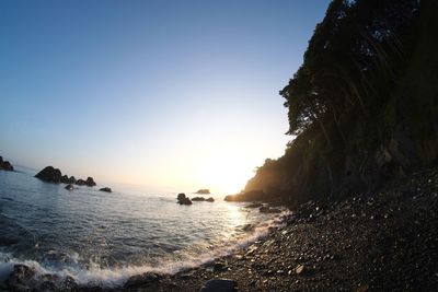 Scenic view of sea against clear sky during sunset