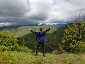 Full length of man standing on mountain against sky