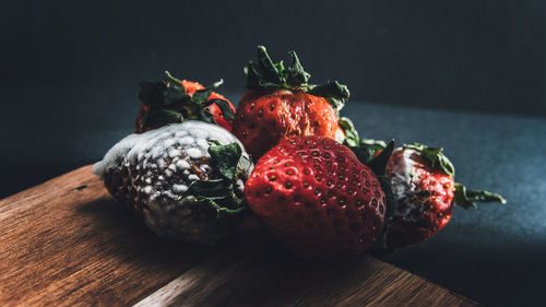 Close-up of strawberries on table against black background