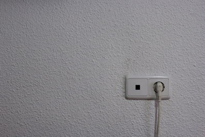 Close-up of electric lamp on wall