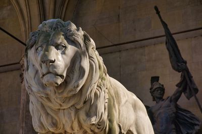 Low angle view of statue against historic building