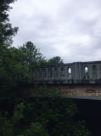 Train by railroad tracks against sky