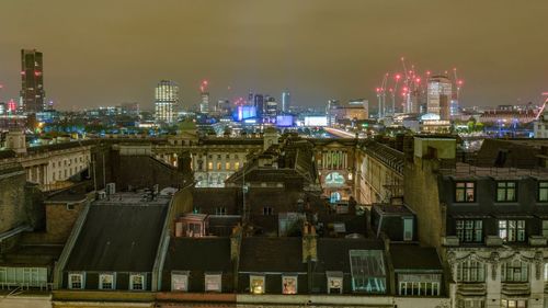 Illuminated cityscape against sky at night