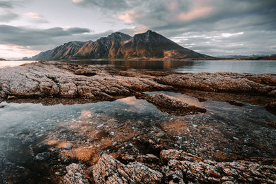 Scenic view of sea and mountains against sky