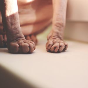 Low section of man relaxing on floor