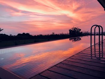 Scenic view of swimming pool against sky during sunset