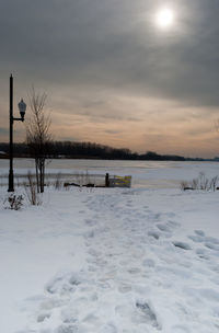 Scenic view of frozen lake against sky during winter