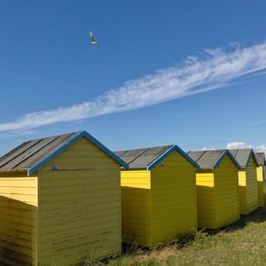 Wooden huts against blue sky