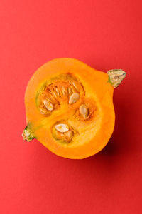 Directly above shot of orange fruit against yellow background