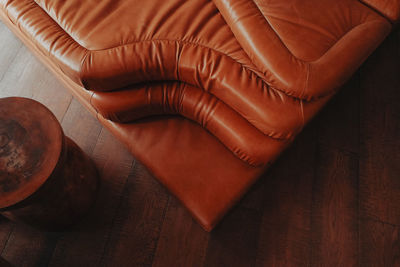 Bright orange sofa in a boho interior. view from above