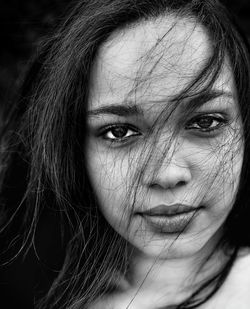 Close-up portrait of young woman with tousled hair