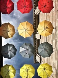 Directly below shots of colorful umbrellas handing against stormy clouds