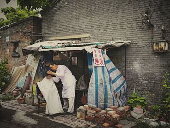 Rear view of people standing outside building