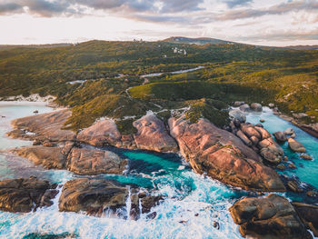 Rocks by sea against sky