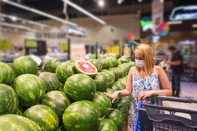 Woman wearing mask shopping at mall