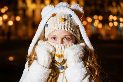 Street portrait smiling beautiful girl on festive christmas street in evening