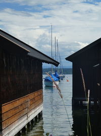 Man standing on pier by sea against sky