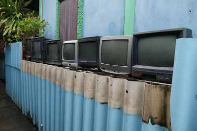 Close-up of telephone booth against wall
