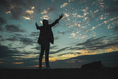 Silhouette man standing against sky during sunset