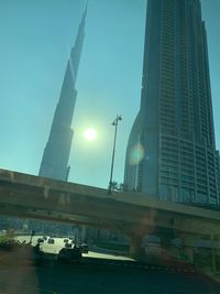 Low angle view of bridge and buildings against sky