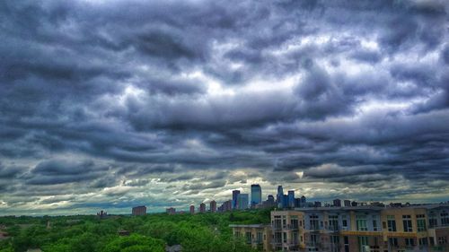 Buildings against cloudy sky