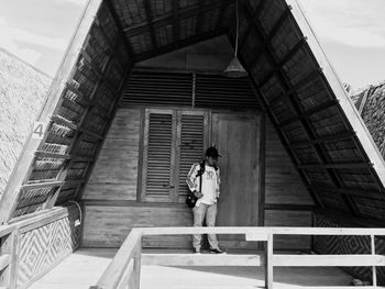 Man standing in built structure during sunny day