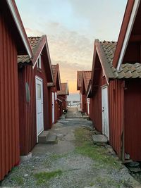 Footpath amidst buildings against sky