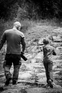 Rear view vather and son on the rock