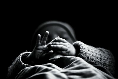 Close-up of child against black background