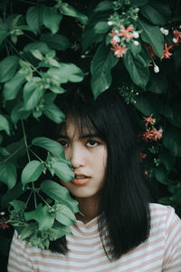 Portrait of woman with green leaves