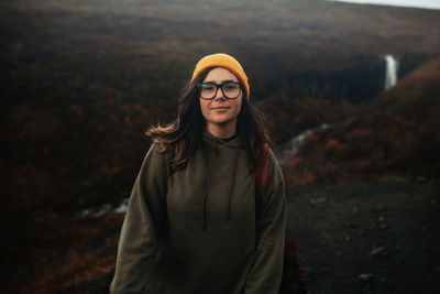 Portrait of smiling young woman standing outdoors