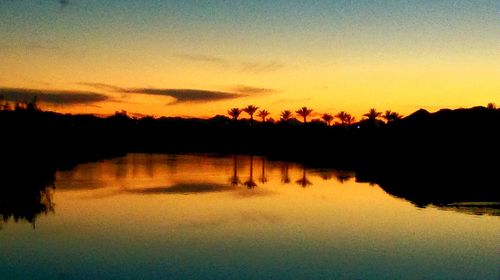 Scenic view of lake at sunset