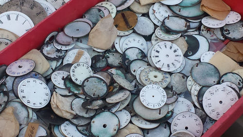 Clock faces of old watches on sale in a stand of vintage market