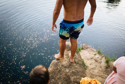 Low section of shirtless boy in water